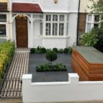 front garden with green tree and masked storage container